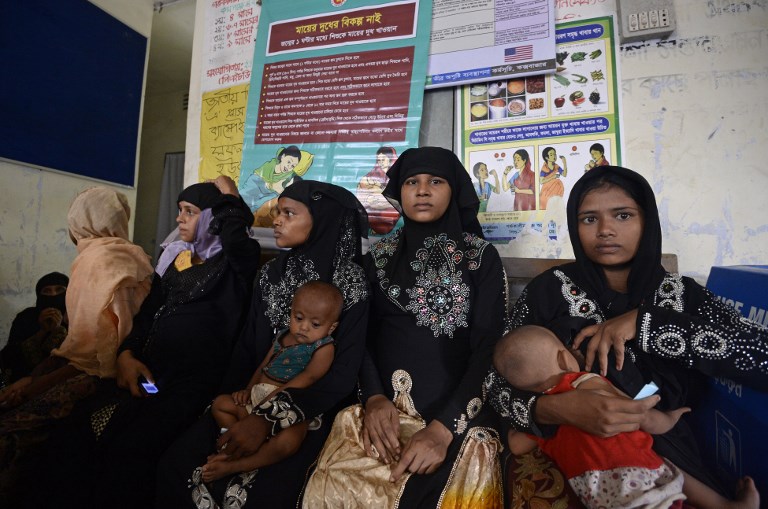 REFUGEES. In this photograph taken on October 24, 2017, Rohingya Muslim refugees look on as they wait inside a government-run family planning center in the Bangladeshi town of Palongkhali. Photo by Tauseef Mustafa/AFP 