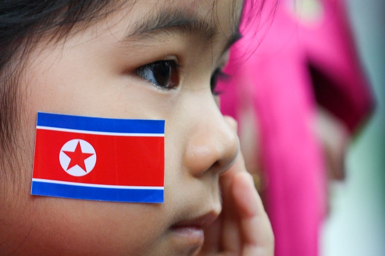 HANOI CHILD. A child, wearing a North Korean flag sticker on her chick, waits outside the Vietnam-North Korea Friendship Kindergarten school in Hanoi on February 27, 2019, ahead of the second US-North Korea summit. Photo by Noel Celis/AFP
 