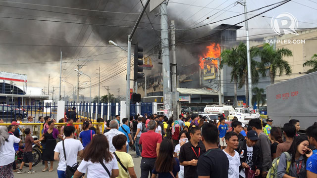EMPLOYEES TRAPPED? Authorities are verifying reports that at least 10 employees of NCCC Mall of Davao are still inside as fire rages on Saturday, December 23, 2017. Photo by Mick Basa/Rappler 