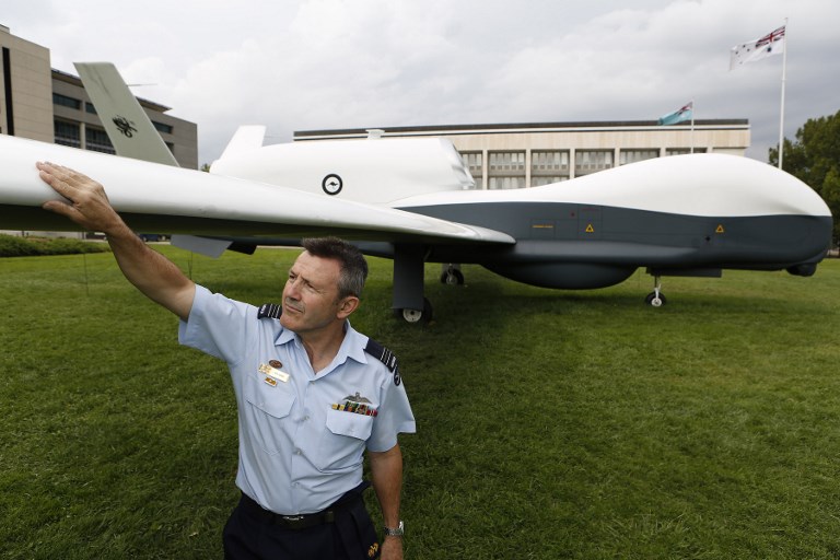 AUSSIE EYE. This handout from the Australian Department of Defense Squadron Leader Col Gray inspecting a full scale mock up of the MQ-4C Triton Unmanned Aerial Vehicle in Canberra. Photo by LAC Michael Green/ Australian Department of Defence/AFP  