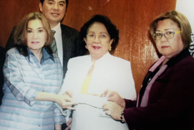 ONLY PDAF. Pork barrel scam whistleblower Ruby Tuason turns over a manager's check worth P40 million to the government in the presence of Ombudsman Conchita Carpio-Morales and Justice Secretary Leila de Lima. De Lima says her immunity only covers the PDAF scam. Photo handout from the Office of the Ombudsman