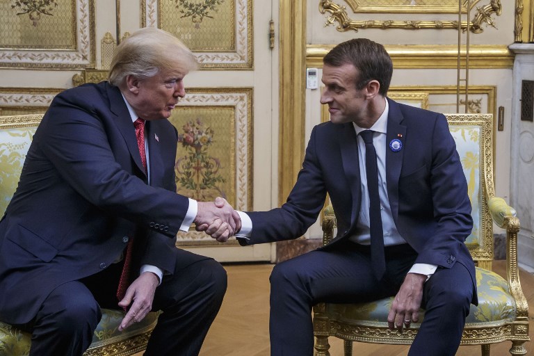 US-FRANCE RELATIONS. US President Donald Trump (L) shakes hands with French president Emmanuel Macron prior to their meeting at the Elysee Palace in Paris, on November 10, 2018, on the sidelines of commemorations marking the 100th anniversary of the 11 November 1918 armistice, ending World War I. Photo by Christophe Petit-Tesson/POOL/AFP 
