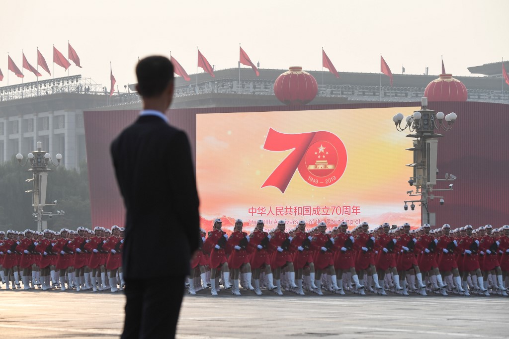 GETTING READY. Chinese troops take part in a rehearsal in front of a screen shows the emblem of the 70th anniversary of the founding of the People's Republic of China ahead of a military parade in Tiananmen Square in Beijing on October 1, 2019. Photo by Greg Baker/AFP 