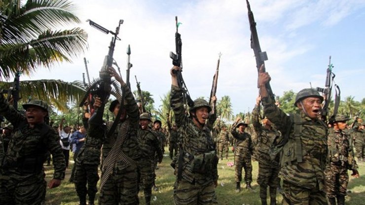 GUNS DOWN. This photo taken on Oct 15, 2012 shows members of Moro Islamic Liberation Front (MILF) shouting 'Allahu Akbar' (God is Great) during a celebration inside camp Darapanan in Sultan Kudarat town in Mindanao, to coincide with the signing of the Framework Agreement. Photo by Karlos Manlupig/AFP
