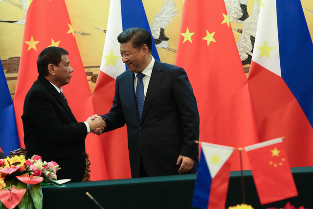 BOOSTING TIES President Rodrigo Duterte shakes hands with President Xi Jinping during his state visit in October 2016. Malacañang file photo  