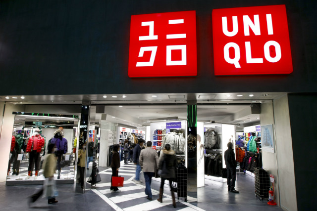 TOP BRAND. Shoppers walk into a Uniqlo shop, known for its low-priced clothes, in Tokyo, Japan, on November 20, 2009. File photo by Dai Kurokawa/EPA 
