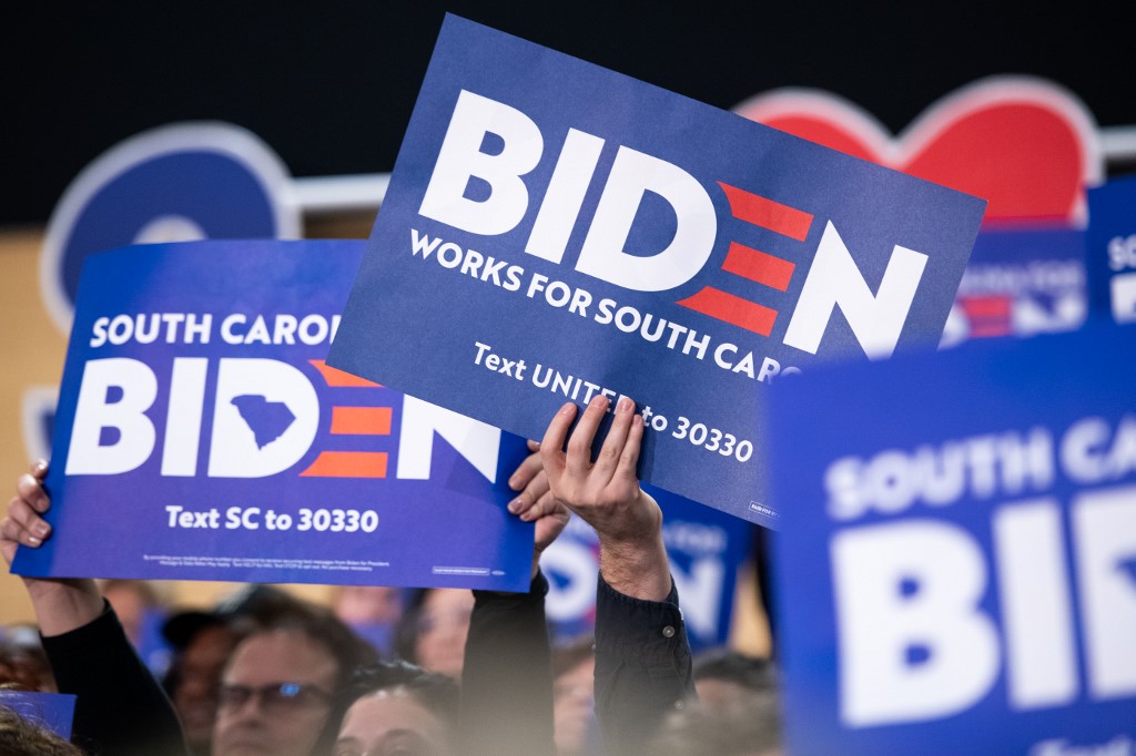WIN? Supporters of Democratic presidential candidate former Vice President Joe Biden hold signs during a campaign event at Wofford University February 28, 2020 in Spartanburg, South Carolina. Photo by Sean Rayford/Getty Images/AFP 