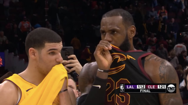 WHISPERS. LeBron James and Lonzo Ball covered their mouths like De Niro and Pesci in the movie Casino to keep their private conversation private. Screenshot from YouTube  