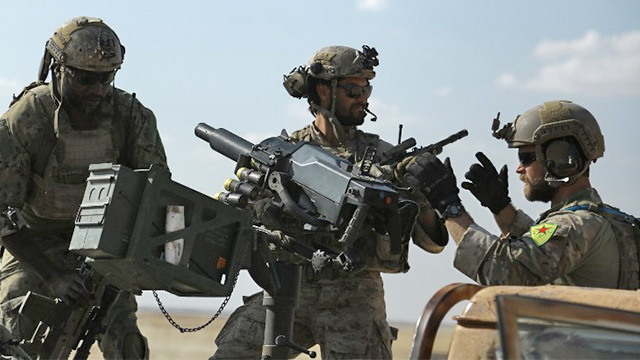 SYRIAN TROOPS. This file photo taken on May 25, 2016 shows men in uniform identified by Syrian Democratic forces as US special operations forces as they ride in the back of a pickup truck in the village of Fatisah in the northern Syrian province of Raqa. US special operations forces photographed in Syria wearing the insignia of Kurdish troops considered terrorists by Turkey have been ordered to remove the patches, a military spokesman said May 27, 2016. Ankara accused the United States, a NATO ally, of "unacceptable" behavior for such an overt display of support for the Kurdish People's Protection Units (YPG). Photo by Delil Souleiman/AFP 