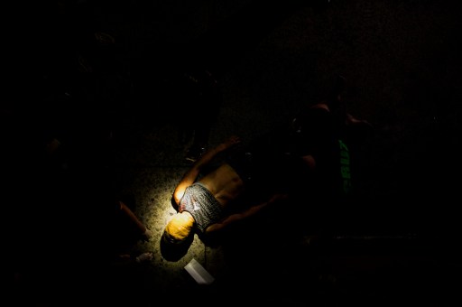 WAR. In this picture taken on July 8, 2016, police officers investigate the body of an alleged drug dealer, his face covered with packing tape, on a street in Manila.
Photo by Noel Celis / AFP 