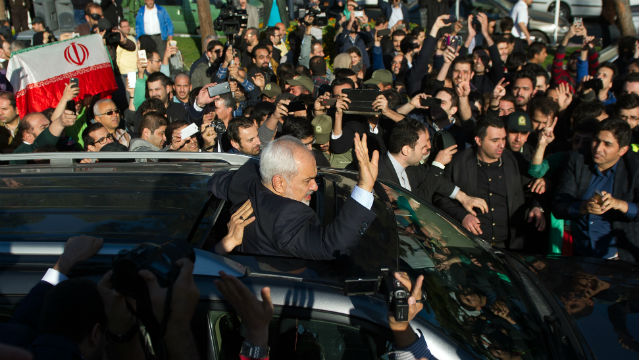 SIGNED. Iranian foreign minister Mohamad Javad Zarif greets his supporters as he arrives from Lausanne, Switzerland to Mehr-Abad airport in Tehran, Iran. Photo by Borna Qasemi/EPA 