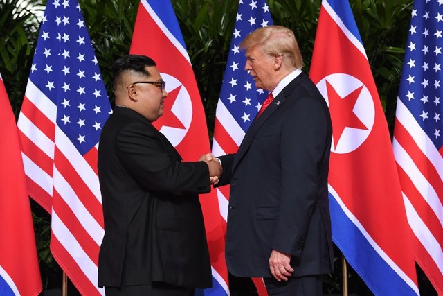 PREPPING FOR A SECOND ROUND. North Korea's leader Kim Jong Un (L) shakes hands with US President Donald Trump (R) at the start of their historic US-North Korea summit, at the Capella Hotel on Sentosa island in Singapore on June 12, 2018. File photo by Saul Loeb/AFP 