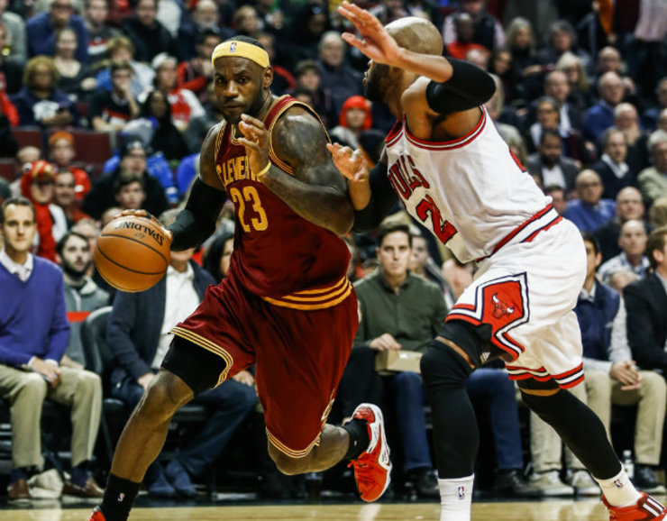 LeBron James blows past Taj Gibson as he wins his first game in his return to Cleveland. Photo by Tannen Maury/EPA