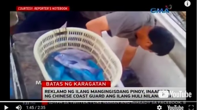 EFFECTIVE CONTROL? A video obtained by GMA News shows a male Chinese taking the catch of Filipino fishermen in Scarborough Shoal. Screenshot of a report on 24 Oras  