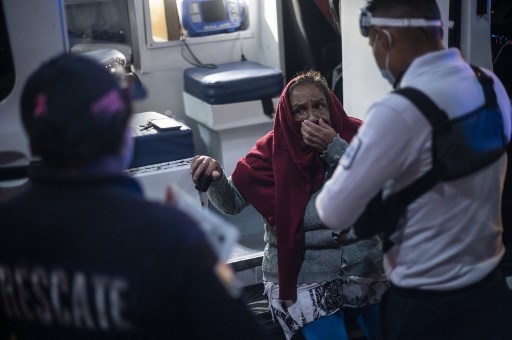 PANDEMIC. A paramedic (R) checks an elderly woman with blood pressure problems in Ciudad Nezahualcoyotl, Mexico State, Mexico, on June 18, 2020 during the COVID-19 novel coronavirus pandemic. Photo by Pedro Pardo/AFP 