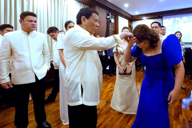 DUTERTE AND CHILDREN. Davao City Mayor Sara Duterte and Davao City 1st District Representative Paolo Duterte flank their father, President Rodrigo Duterte, before the latter's 3rd State of the Nation Address in July 2018. Presidential Photo 