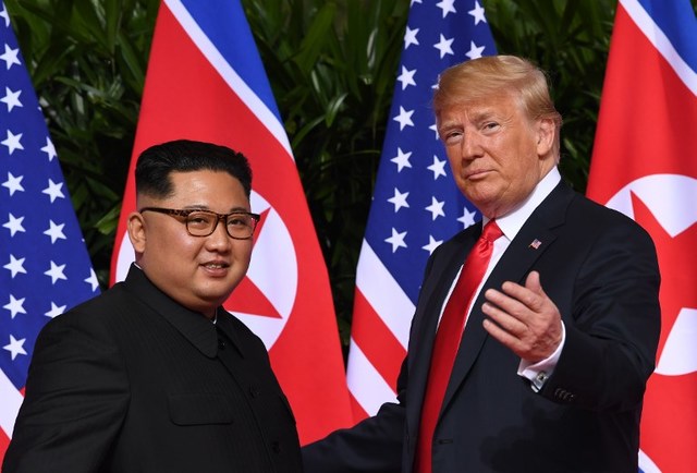 MORE TALKS? US President Donald Trump (R) gestures as he meets with North Korea's leader Kim Jong Un (L) at the start of their historic US-North Korea summit, at the Capella Hotel on Sentosa island in Singapore on June 12, 2018. File photo by Saul Loeb/AFP 