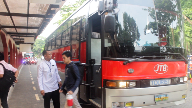LONE PASSENGER. Ateneo Senior High School student Ken Tabagan disembarks from the shuttle bus where he was the only student passenger. Photo by Rendell Sanchez/Rappler 