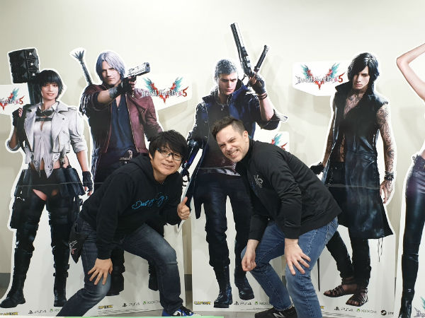 Game director Hideaki Itsuno (left) and producer Matt Walker pose for photos alongside standees of characters from the game at the Datablitz office. Photo by Kyle Chua/Rappler 
