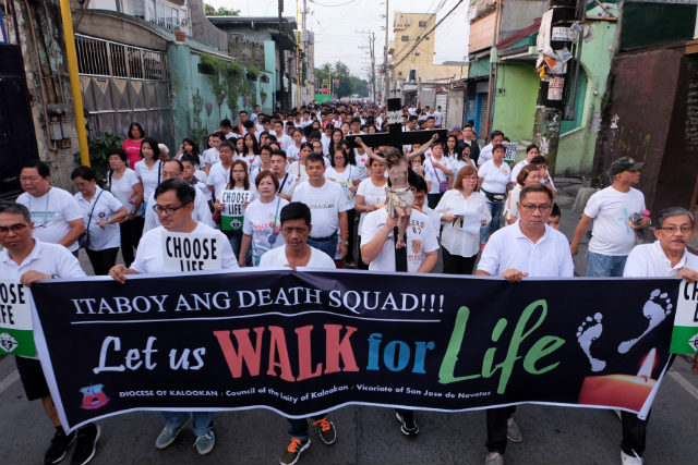 LED BY THE CROSS. Hundreds of Catholics join the Walk for Life in Navotas City at around 5 am on July 2, 2017, to protest against the drug war killings in the Philippines. Photo by Roy Lagarde 