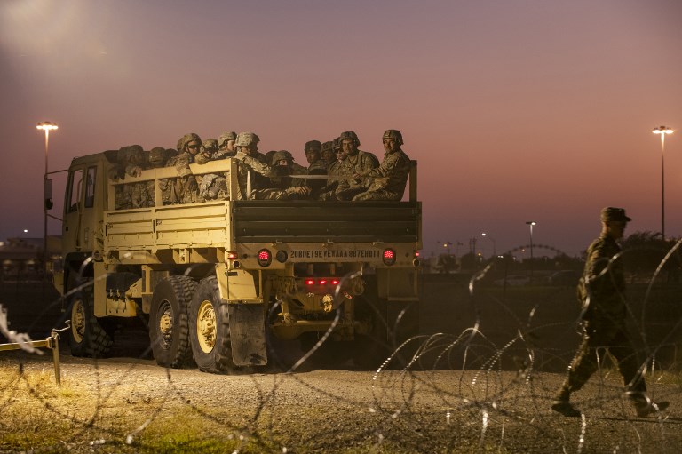 BORDER GUARDS. In this file photo taken on November 06, 2018 US Army troops enter a compound where the military is erecting an encampment near the US-Mexico border crossing at Donna, Texas. Photo by Andrew Cullen/AFP  