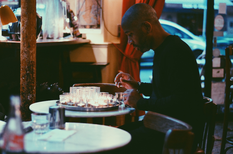 LIFE CONTINUES. The bartender at Le Petit Louis proceeds with his normal routine of lighting candles for dinner service. Photo by Chad Versoza 