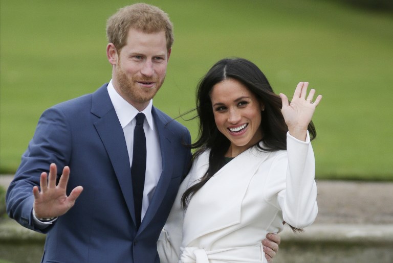 WEDDING. This file photo taken on November 27, 2017 shows Britain's Prince Harry and his fiancée US actress Meghan Markle posing for a photograph in the Sunken Garden at Kensington Palace in west London following the announcement of their engagement. Meghan Markle is to become the first fiancée invited to spend Christmas with the British royal family December 14, 2017, a move hailed as a sea change in the monarchy's traditionalist attitude. Photo by
Daniel Leal- Olivas/ AFP  