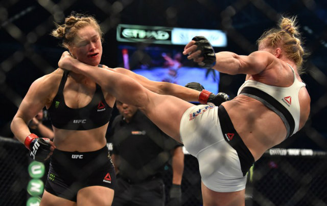 PREACHER'S DAUGHTER. Holly Holm lands a left kick to Ronda Rousey's face en route to the one-sided knockout win. Photo by Paul Crock/AFP 