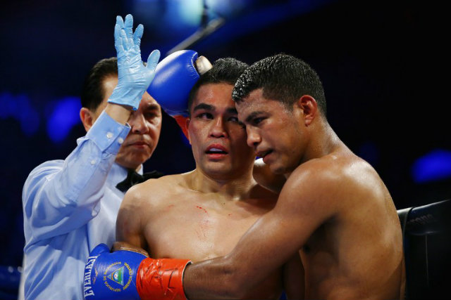 Roman Gonzalez embraces Brian Viloria as the referee waves off the fight. Photo by Al Bella/Getty Images/AFP