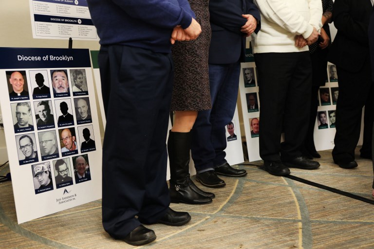 JUSTICE. Survivors of sexual abuse by priests and clergy stand before photos of accused religious men during a news conference on February 14, 2019, in New York City. Photo by Spencer Platt/Getty Images North America/AFP   