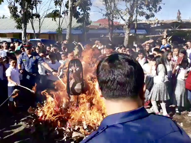 MOMO BURNED. Cops lead students in burning an image of the viral Momo challenge in Butuan City. Caraga police photo 
