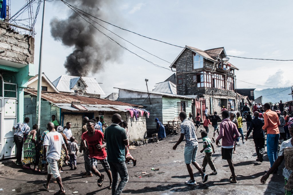 PLANE CRASH. Residents react after a small aircraft carrying around 15 passengers crashed in a densely populated area in Goma on the east of the Democratic Republic of Congo on November 24, 2019. Photo by Pamela Tulizo/AFP 