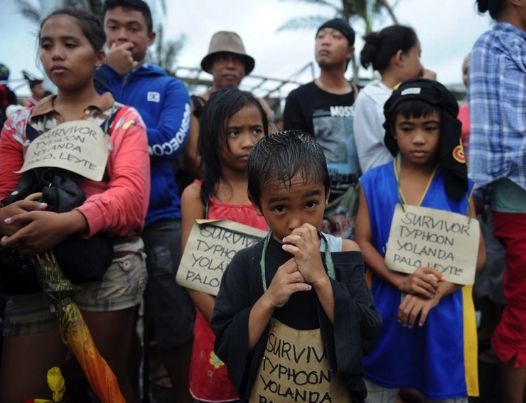 SURVIVOR. This file photo taken on November 12, 2013, shows survivors of Super Typhoon Haiyan, waiting for a C-130 military plane at Tacloban airport, Leyte province. File photo by Ted Aljibe/AFP