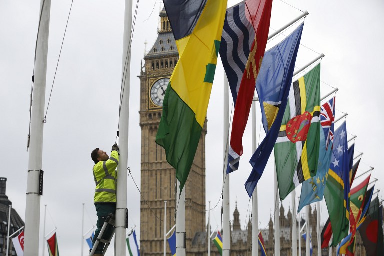 COMMONWEALTH. A workman erect flags of the Commonwealth Nations in Parliament Square in front of the House of Commons in London on March 10, 2013 on the eve of Commonwealth Day. File photo by Justin Tallis/AFP 
