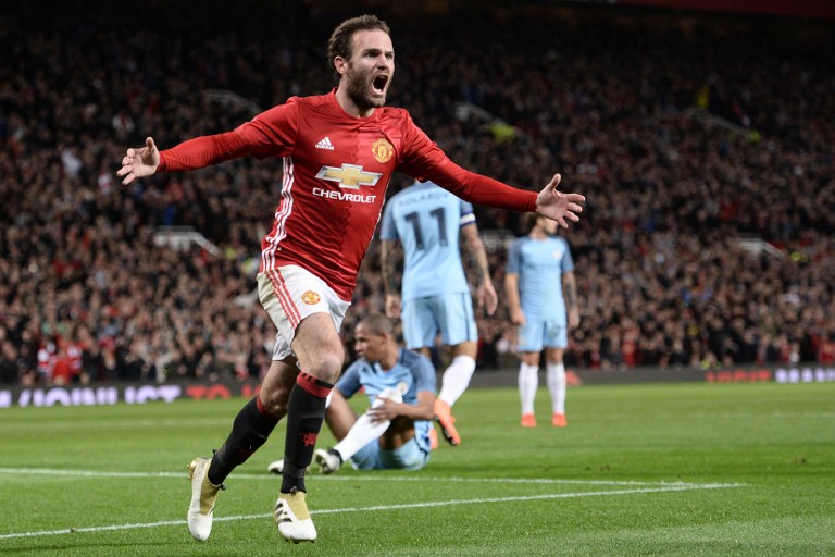 DERBY WINNER. Manchester United's midfielder Juan Mata celebrates after scoring the winning goal in a derby match against Manchester City. Photo by Oli Scarff/AFP  