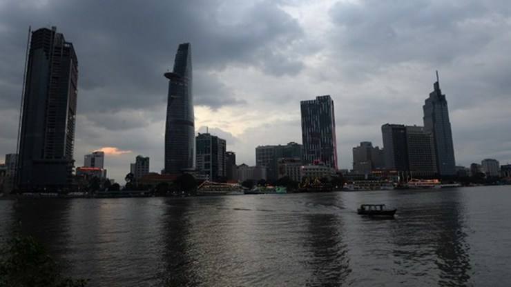 ECONOMIC GROWTH. This picture taken on December 14, 2014 shows buildings of the financial district of Ho Chi Minh city looming over the Saigon River. Photo by Hoang Dinh Nam/AFP 