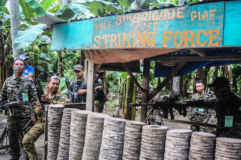 NOT SURRENDER. Moro Islamic Liberation Front (MILF) rebels stand guard at the entry of Camp Darapanan, Sultan Kudarat on September 7, 2019 ahead of a weapons decommissioning ceremony. Photo by Ferdinandh Cabrera/AFP  