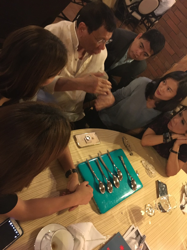 PROPS. President Duterte uses spoons and a laptop to explain his take on climate change. Photo by Cedric Castillo/GMA7