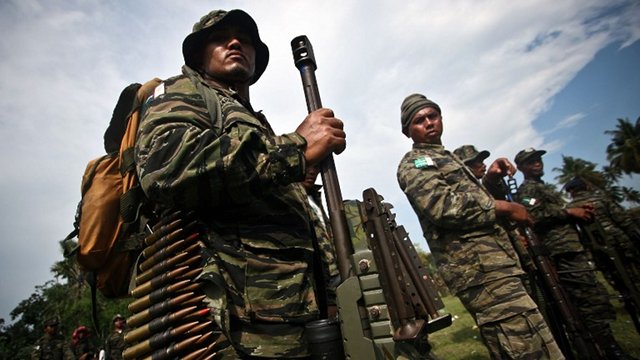 ARMS DEAL. This photo taken on Oct 15, 2012 shows members of the Moro Islamic Liberation Front (MILF) standing in formation during a celebration inside Camp Darapanan in Sultan Kudarat town, in the southern island of Mindanao. Photo by Karlos Manlupig/AFP 