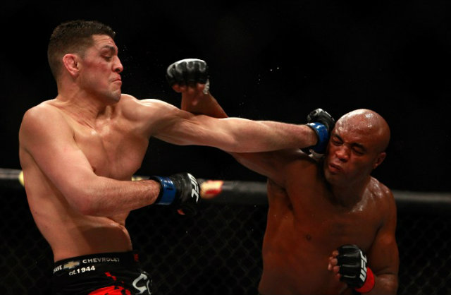 Anderson Silva (R) and Nick Diaz (L) trade punches during their UFC 183 match. Photo by Steve Marcus / Getty Images / AFP <span class=
