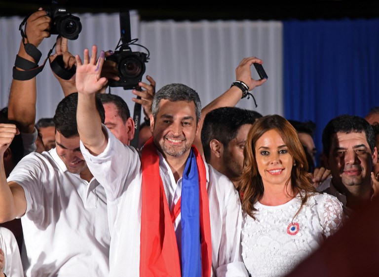 THE NEW PRESIDENT. Paraguay's new President and presidential candidate of the Colorado Party, Mario Abdo Benitez (R), next to his wife Silvana Lopez Moreira, wave to the crowd at Partido Colorado headquarters in Asuncion on April 22, 2018. Photo by Norberto Duarte/AFP 