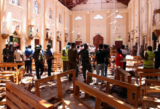 TRAGEDY. Sri Lankan security personnel walk through debris following an explosion in St Sebastian's Church in Negombo, north of the capital Colombo, on April 21, 2019. Photo by STR/AFP 