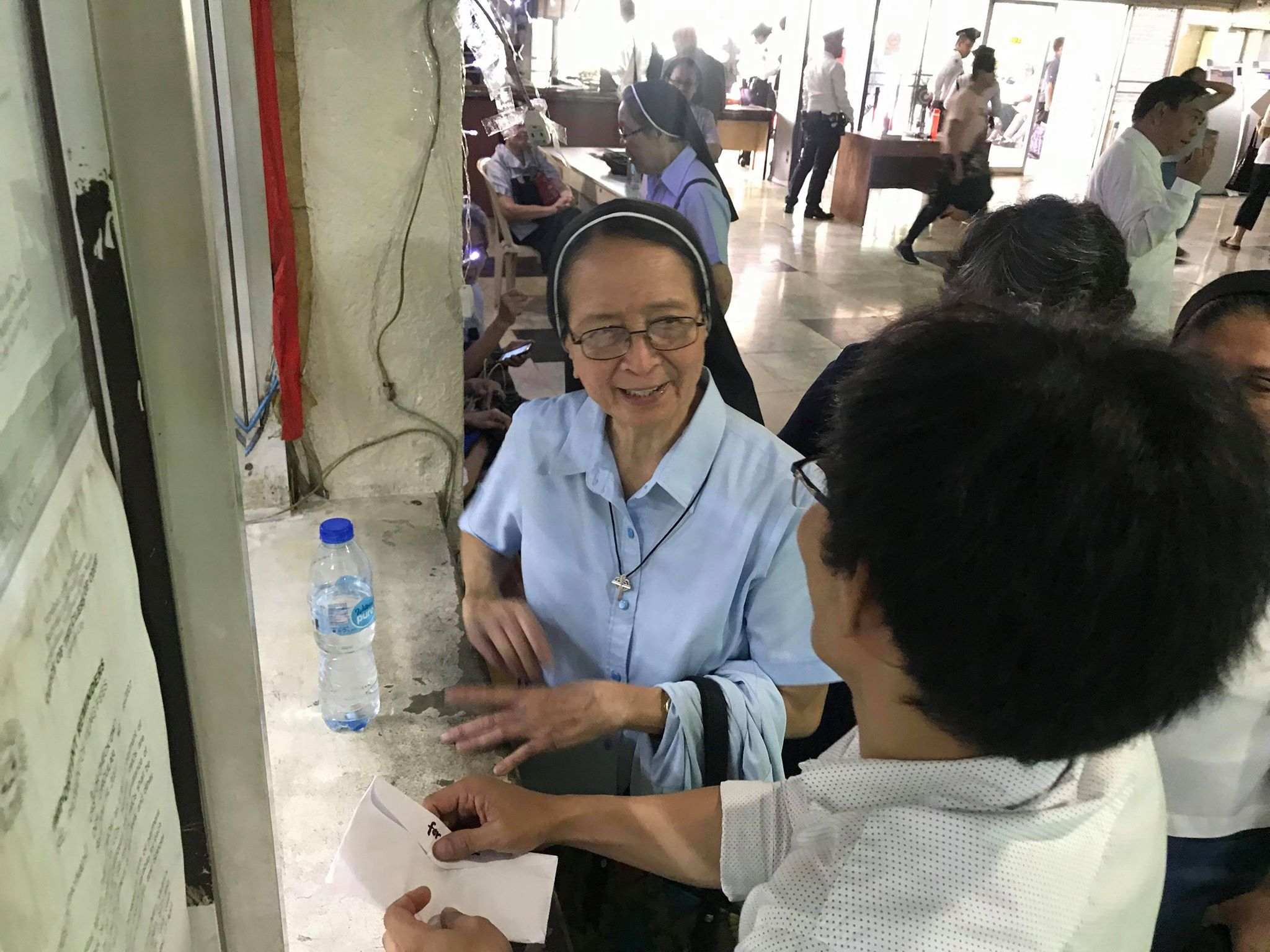 COURT PROCESS. Sister Elenita Belardo pays P18,000 bail at the Quezon City Metropolitan Trial Court over one count of perjury rooted from the complaint of National Security Adviser Hermogenes Esperon Jr. Photo courtesy of Karapatan   
