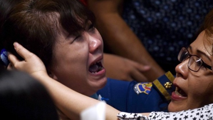 DEVASTATING NEWS. Family members of passengers onboard the missing Malaysian air carrier AirAsia flight QZ8501 react after watching news reports showing an unidentified body floating in the Java sea, inside the crisis-centre set up at Juanda International Airport in Surabaya on December 30, 2014. Photo by Manan Vatsyayana/AFP
