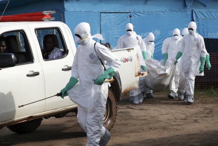 HEALTH WORKERS. A photograph made available 27 July 2014 shows Liberian health workers in protective gear on the way to bury a woman who died of the Ebola virus from the isolation unit in Foya, Lofa County, Liberia, 02 July 2014. Ahmed Jallanzo/EPA