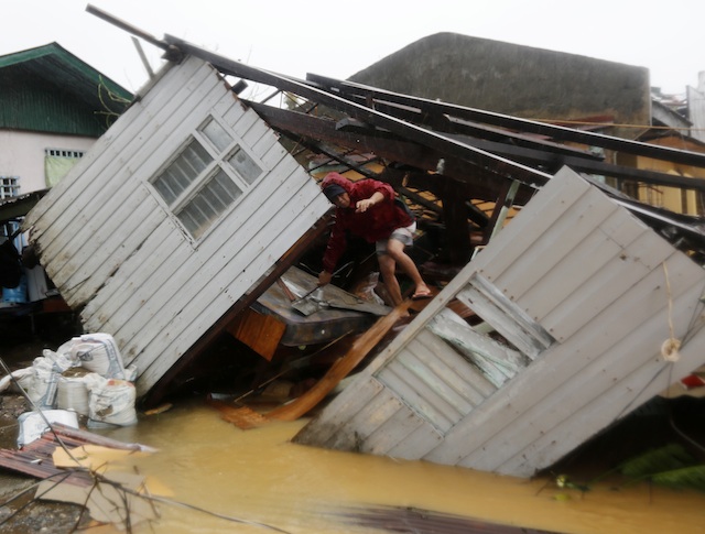TYPHOON RUBY. A man steps out of a house damaged by Typhoon Ruby in Borongan, Eastern Samar, on December 7, 2014. Photo by Francis Malasig/EPA