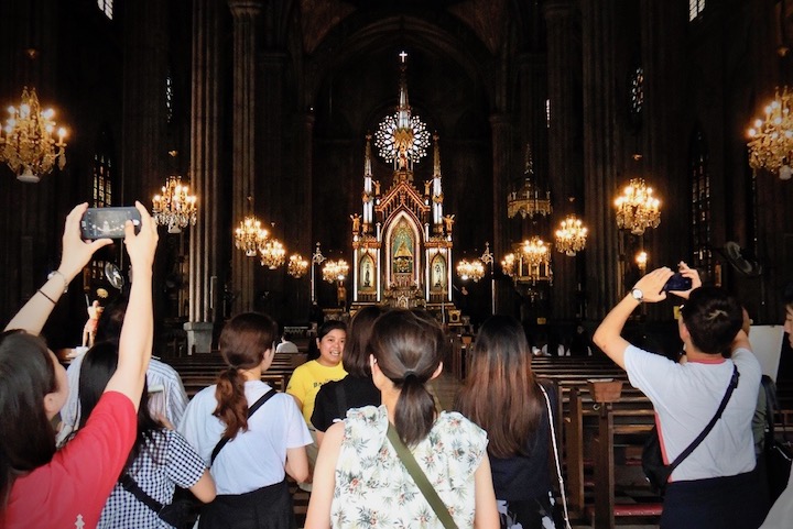 GRAND CHURCH. A tour guide leads guests inside the main hall of the San Sebastian Church. Photo from the San Sebastian Church Conservation and Development Foundation 