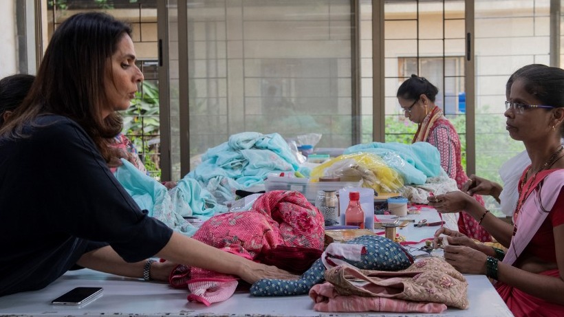 ANITA DONGRE. The fashion designer from India interacts with a worker at her clothing factory on the outskirts of Mumbai. Photo by LaurÃ¨ne Becquart/AFP 