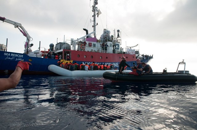 MIGRANTS. This handout picture obtained on June 22, 2018 from the German NGO 'Mission Lifeline' shows migrants on an inflatable boat boarding the Lifeline sea rescue boat at sea on June 21, 2018. Photo by Hermine Poschmann/Mission Lifeline/AFP 