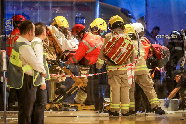 CHAOS. Paramedics carry away a wounded person on a stretcher after a bloody knife fight broke out at a shopping mall in Hong Kong on November 3, 2019. Photo by Vivek Prakash/AFP 